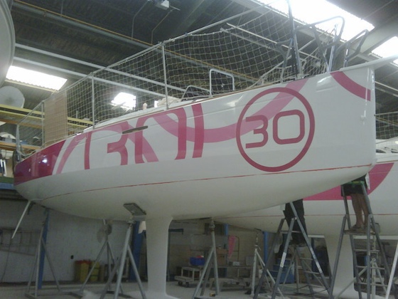 Lined up at the factory, fast new 30-footers from Beneteau get the hot pink treatment.