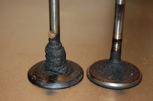 The outboard motor intake valve on the left has been completely fouled with fiberglass resin dissolved in E10 ethanol-blend fuel.