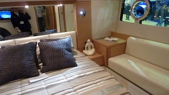 The master stateroom, with seating and a large window outboard on either side.